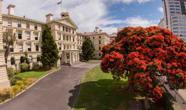 Victoria University of Wellington's Law School, pictured in summer with trees in bloom.