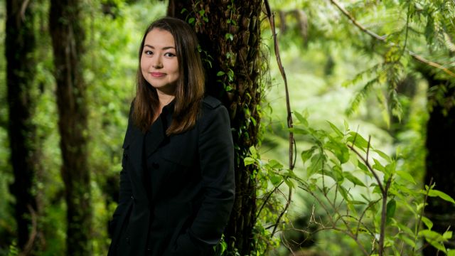 Salina Fisher in a green wooded area.