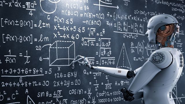A robot stands in front of a blackboard with equations and shapes displayed on it.