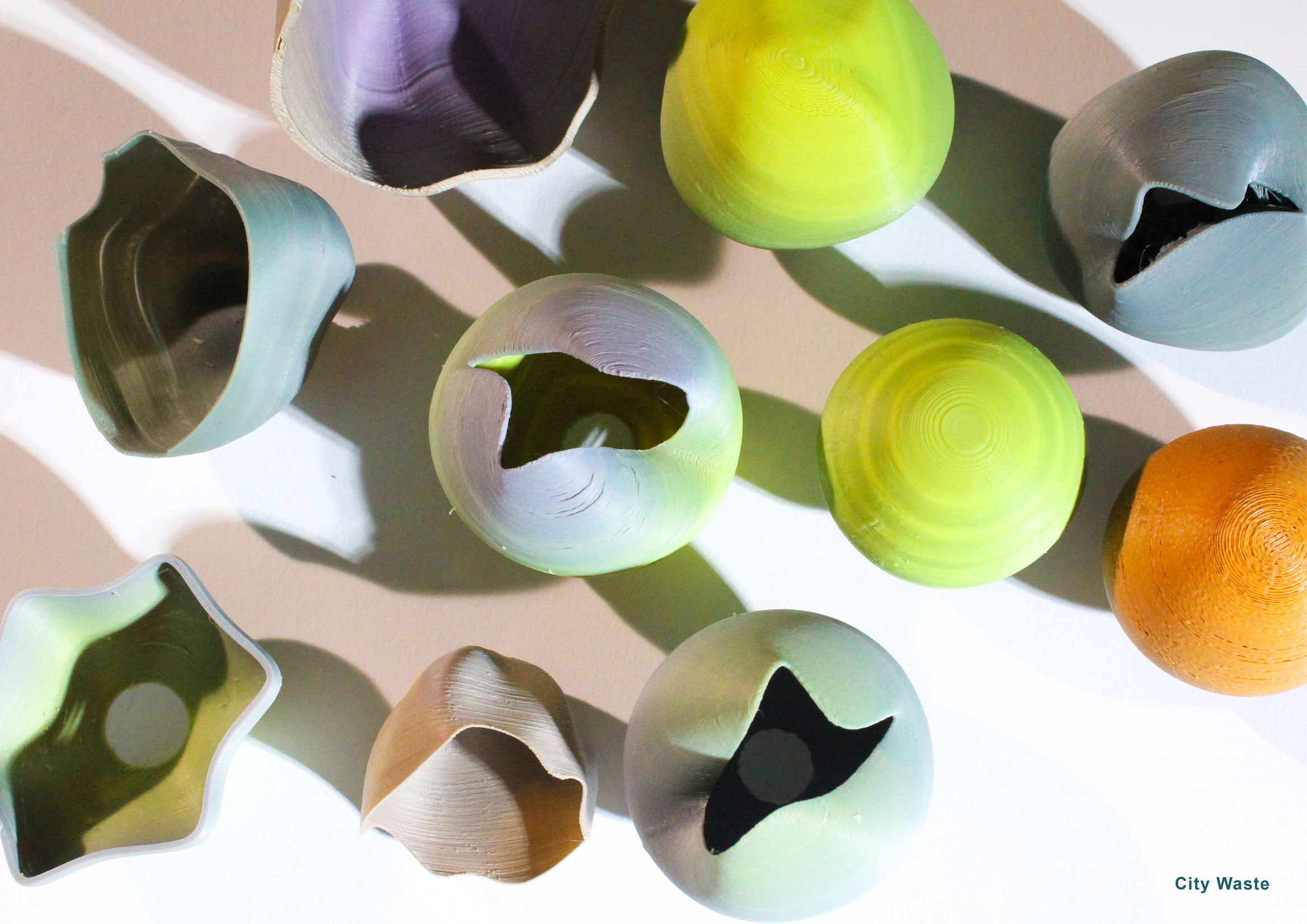 overhead view of vases and lampshades created from upcycled plastic in a variety of obre colours