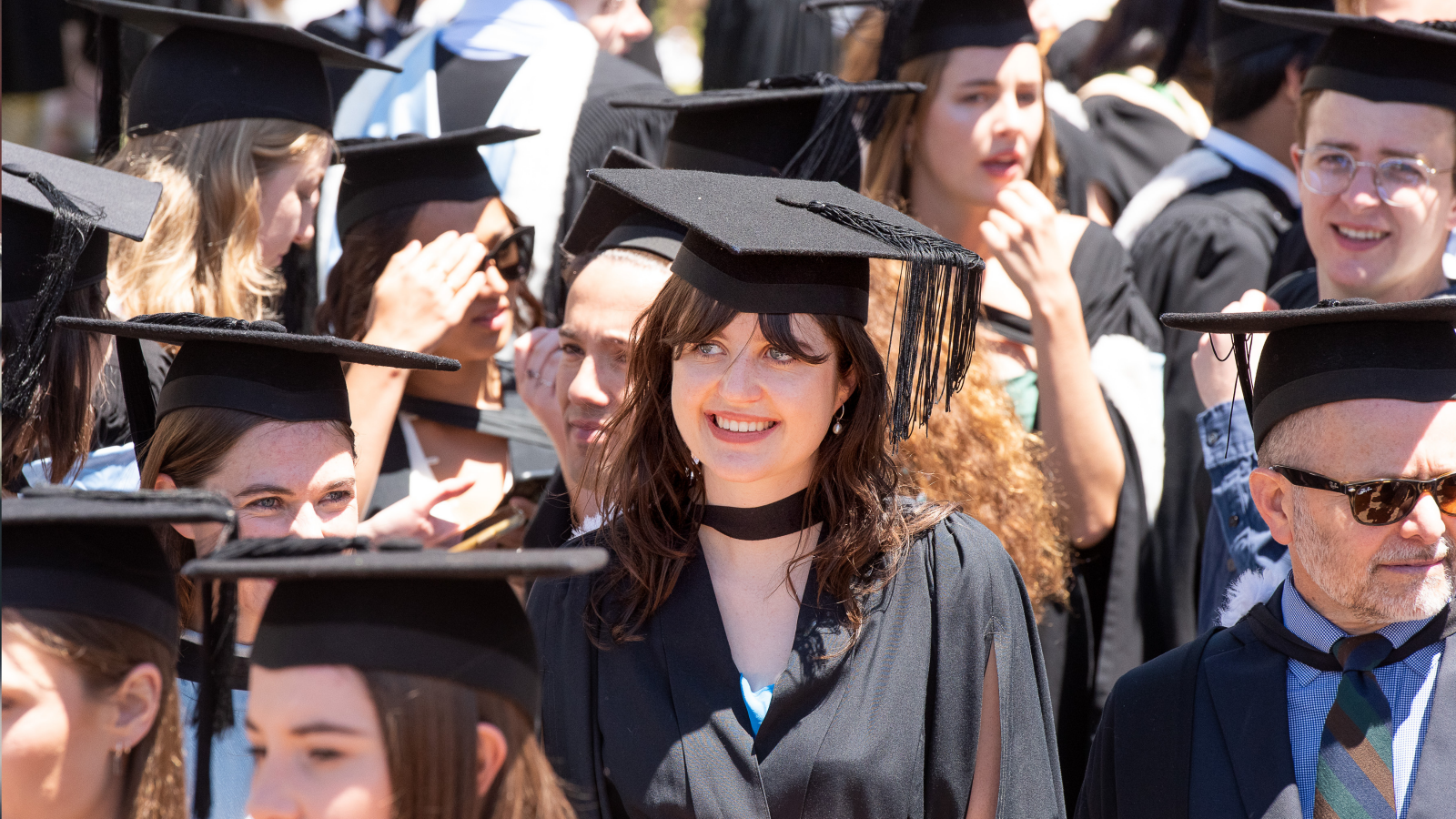 girl smiling in middle of graduates in civic square wellington 