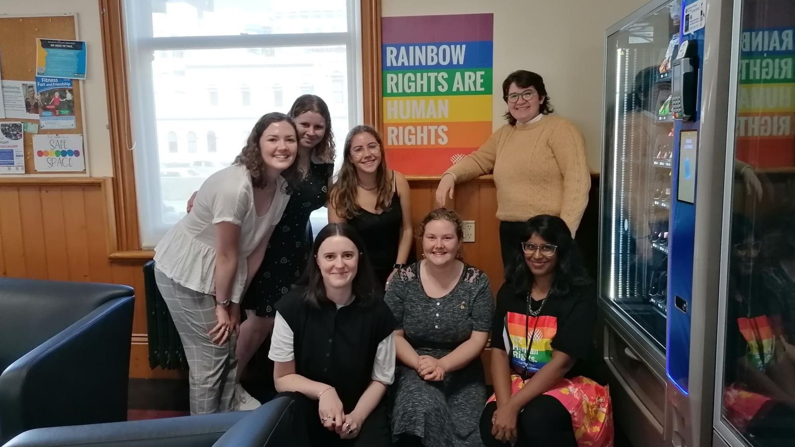 Group picture of Rainbow Law Students Association executive team, in from of rainbow poster with message 'rainbow rights are human rights'.