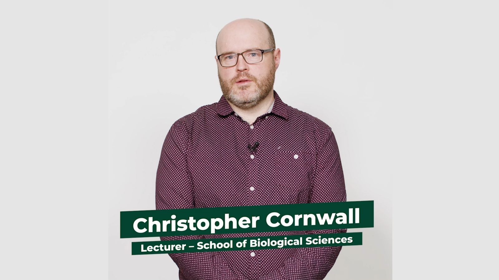 Lecturer Christopher Cornwall stands facing the camera against a white background