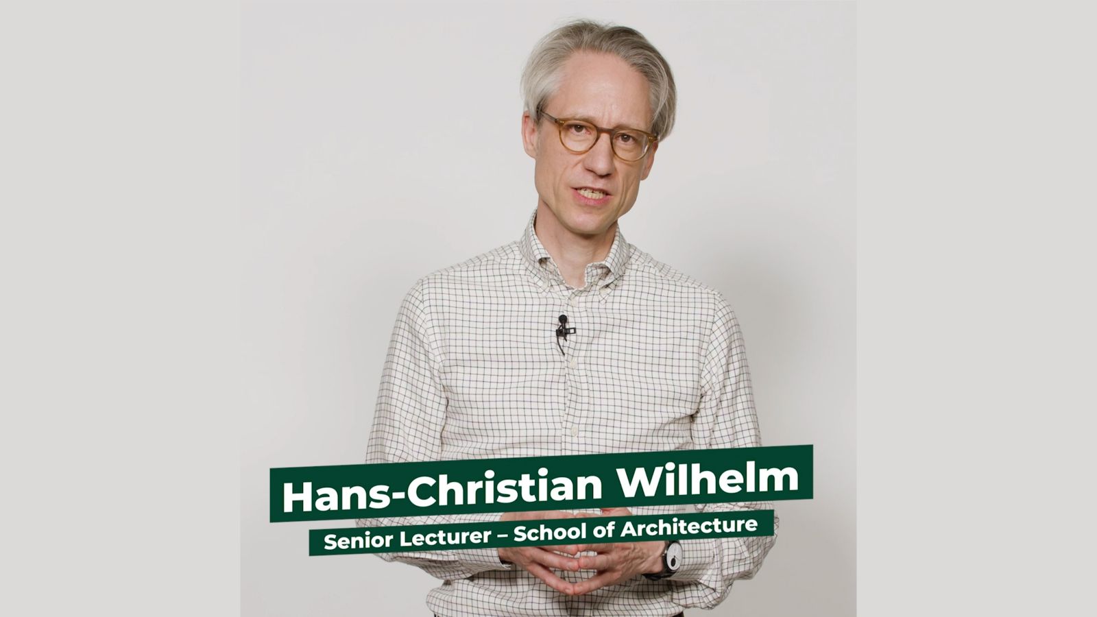 Senior Lecturer at the School of Architecture Hans-Christian Wilhelm stands facing the camera against a white backdrop.