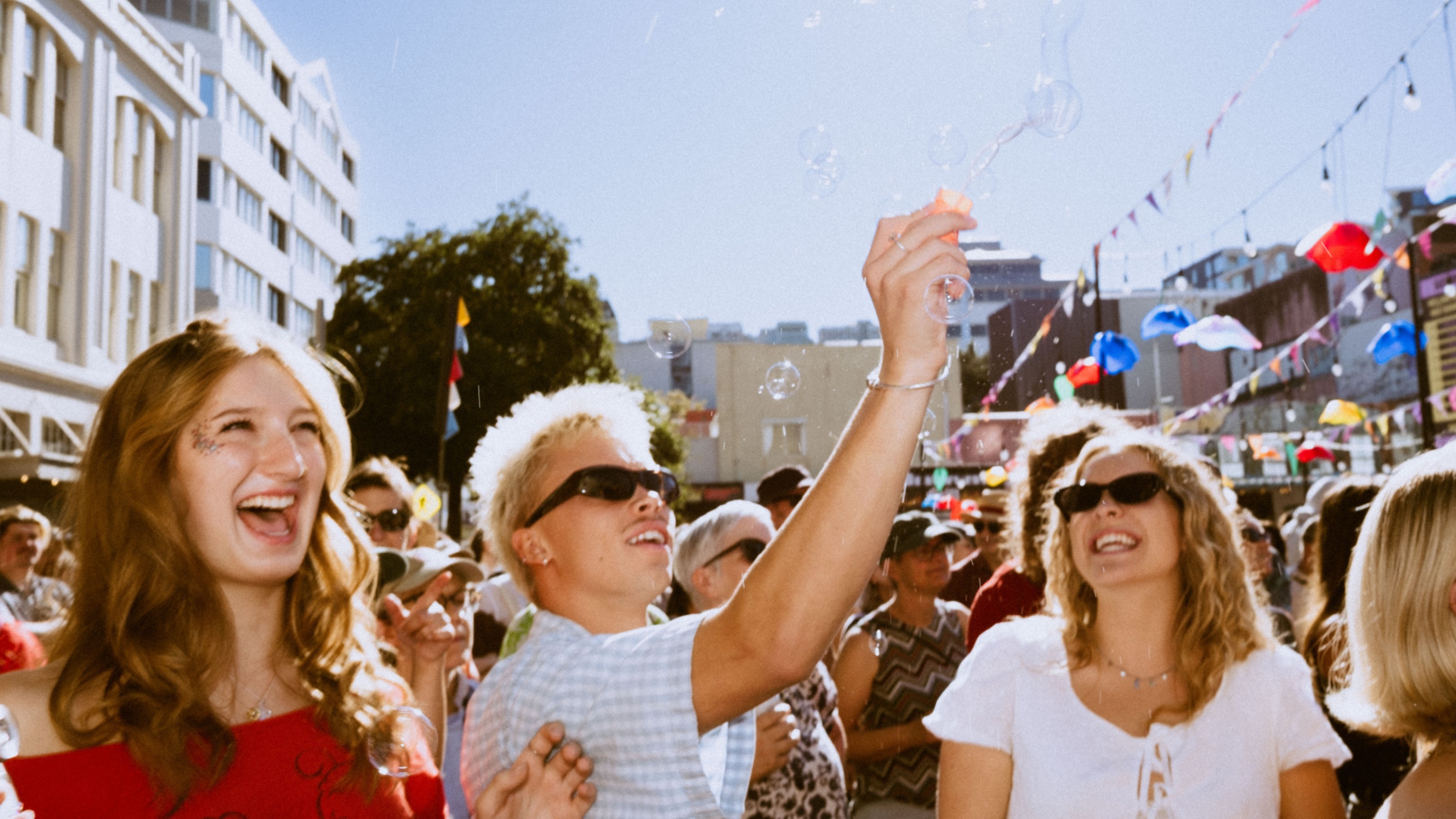Students enjoying Cuba Dupa street festival, blowing bubbles in the street