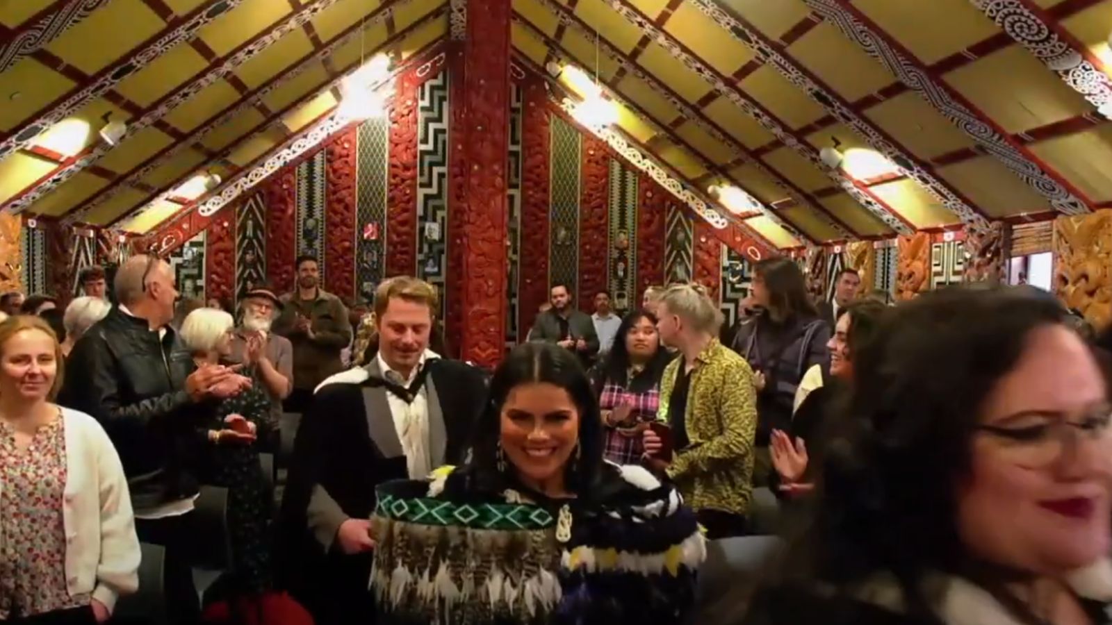 Graduates walk into the marae for Te Hui Whakapūmau, surrounded by their friends and whānau.