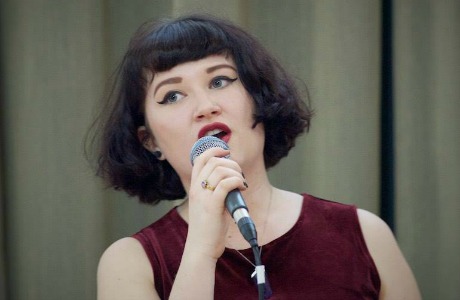 Lauren singing into a microphone