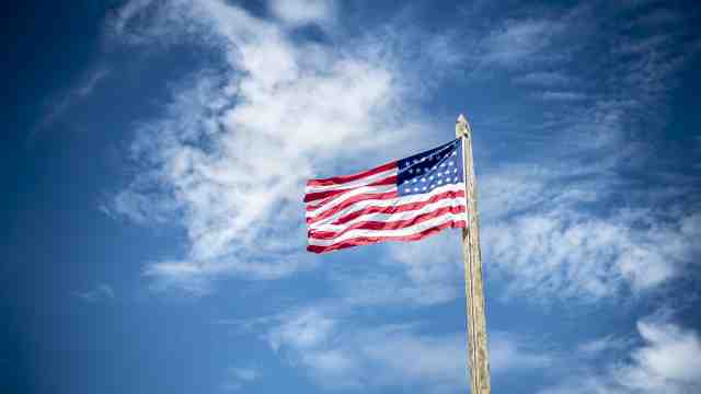 The American flag against a blue sky.
