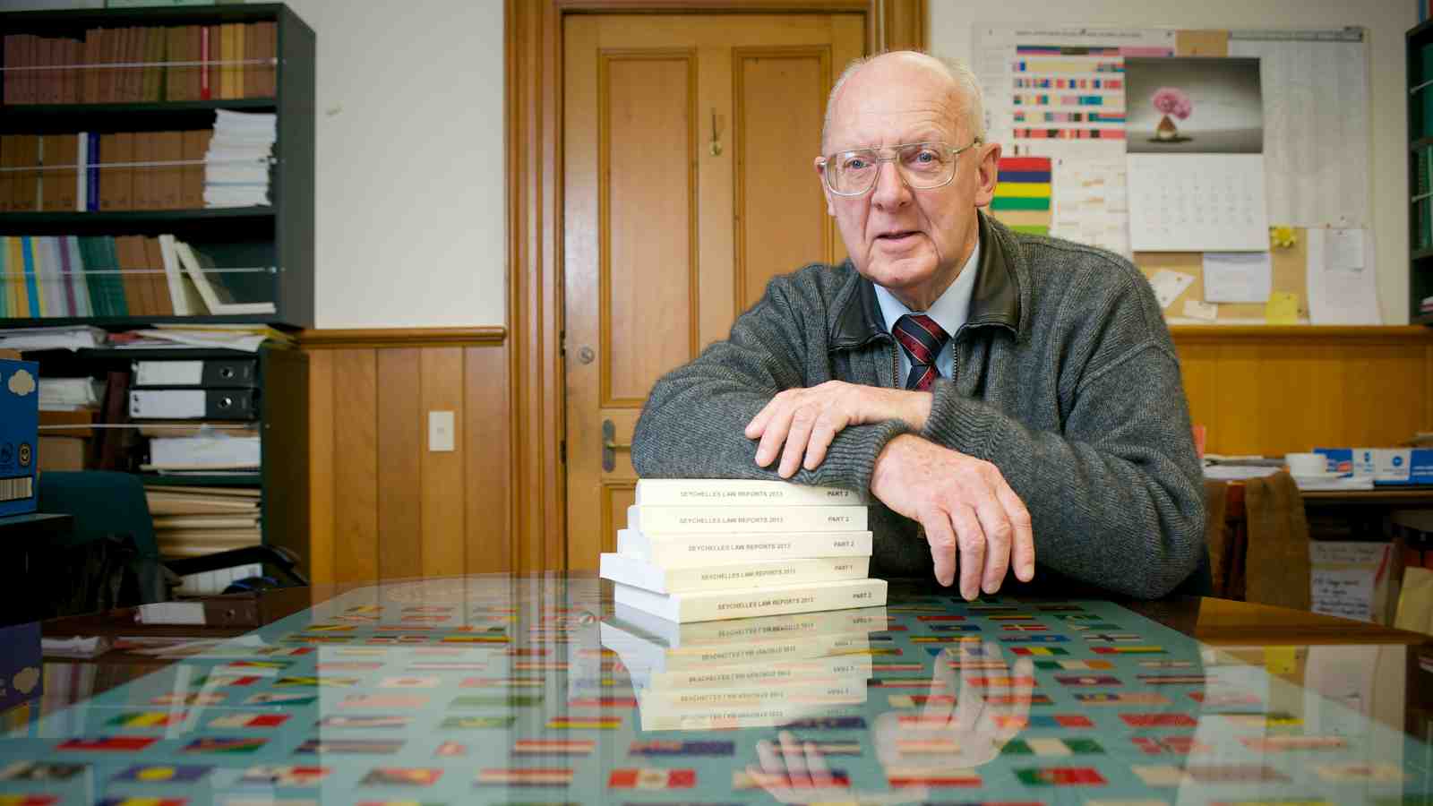 Professor Tony Angelo QC sitting at a table in his office.