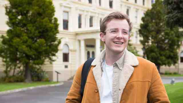 Max Bicknell in front of Victoria University of Wellington's Law School.