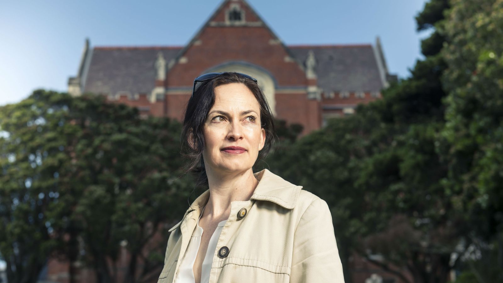 Associate Professor Rebecca Priestley stands outside the red brick hunter building.