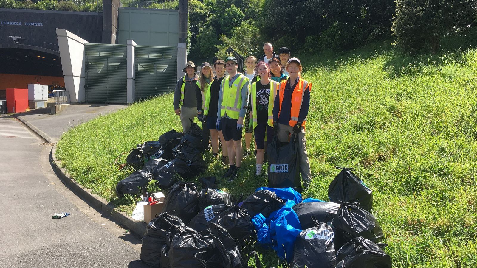 Student volunteers standing in front of the rubbish collected