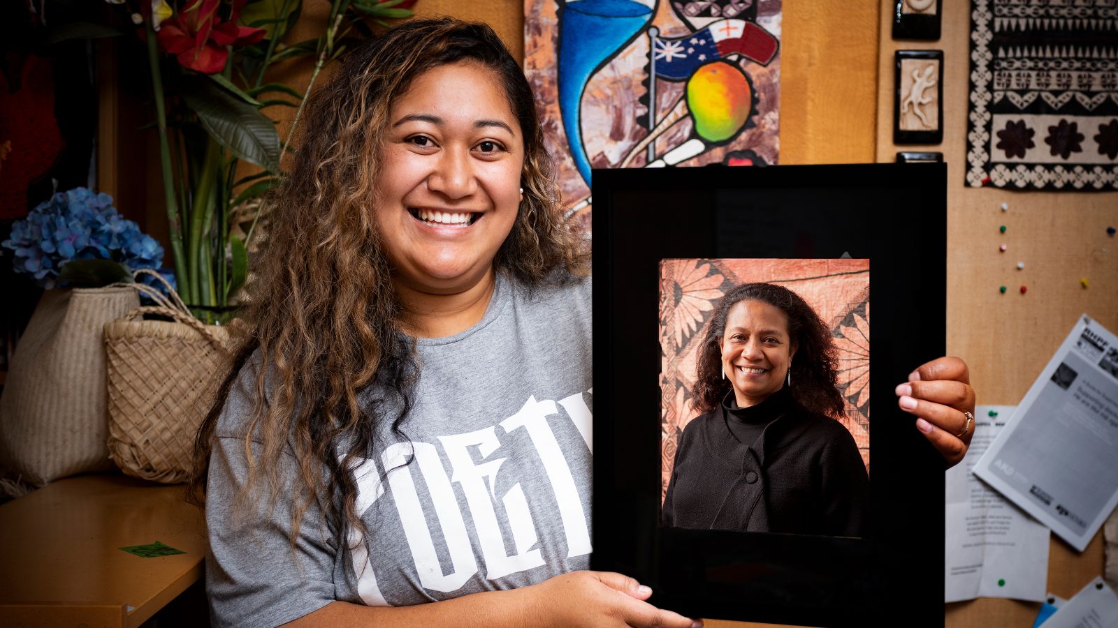 Alilia Tupou with a portrait of Associate Professor Teresia Teaiwa.