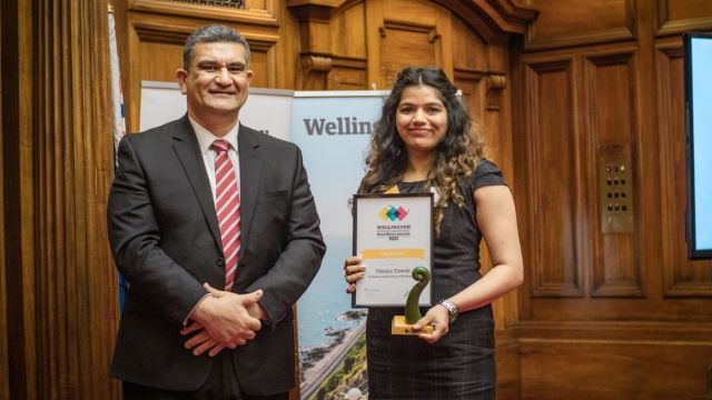Vinaya Tawde accepts her award from Paul Eagle MP during the Awards Ceremony in the Great Hall, Parliament Buildings