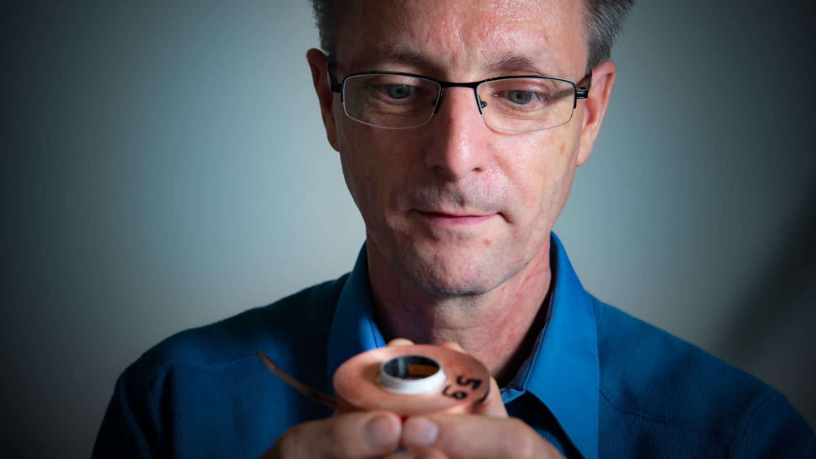 Dr Huub Weijers holding a high-field magnet.