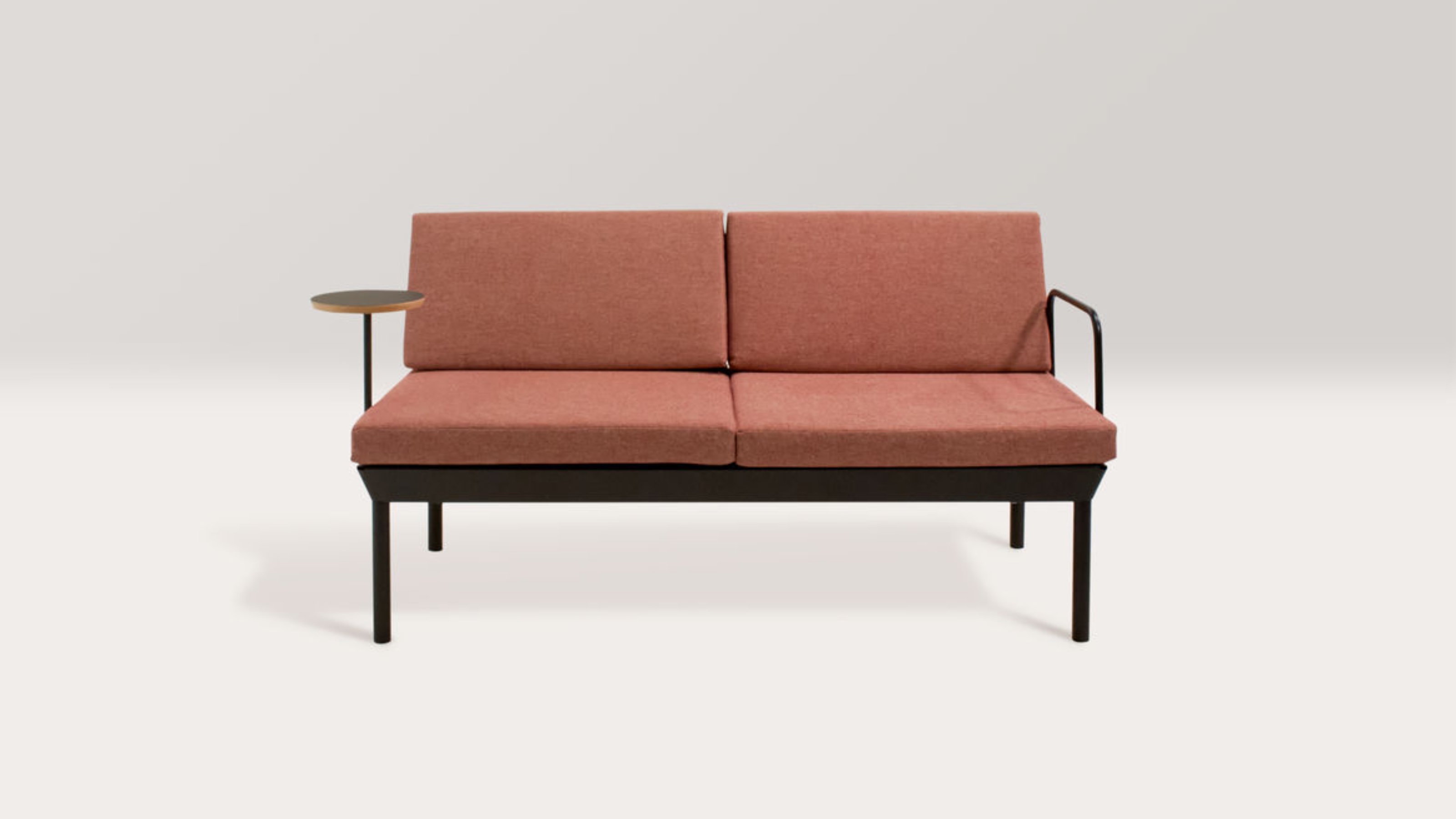 Light red canvas sofa with dark metal frame.