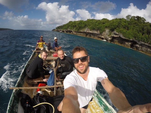 James Bell and research team on boat on the shore of Jaco Island