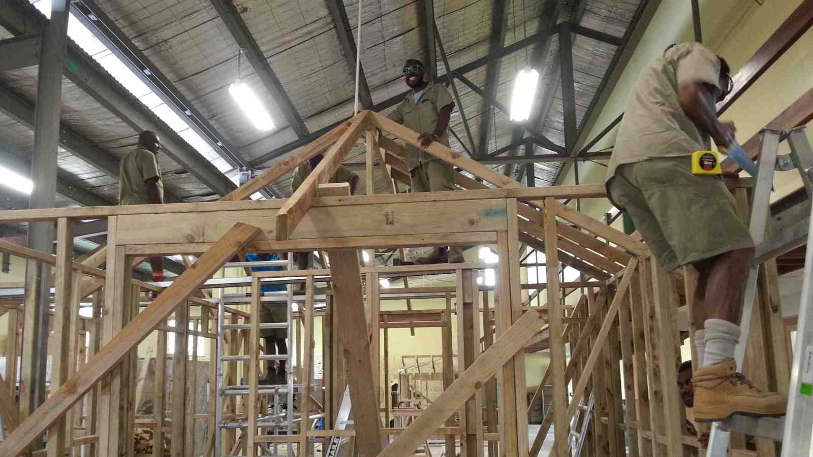 Local carpenters working on the frame of the new model kindergarten in Vanuatu.