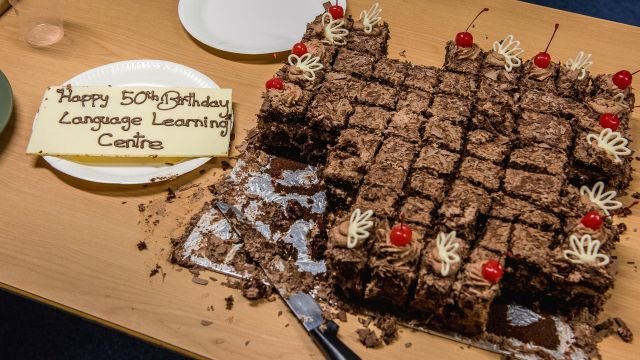 Chocolate cake with message wishing the Language Learning Centre an happy 50th birthday.