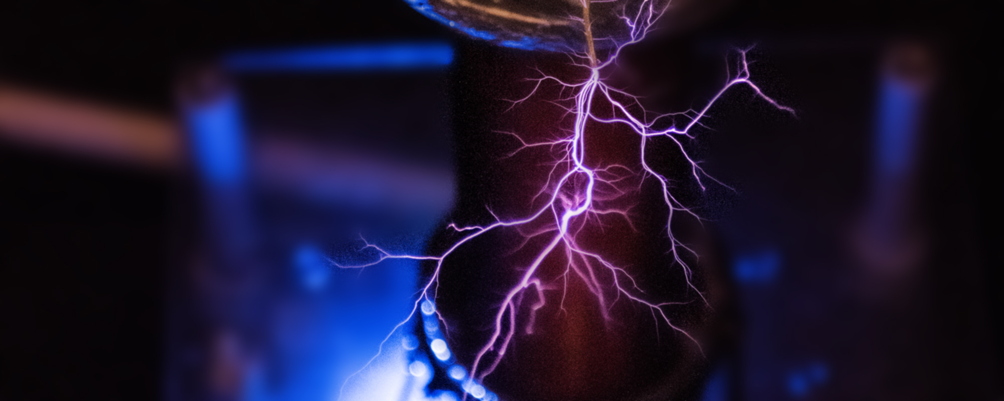 An image of pink electricity coming off of a tesla coil.