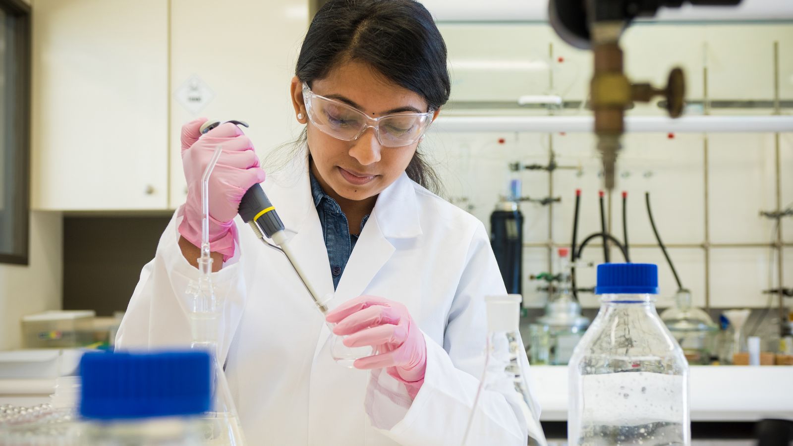 organic-science-3200x1800.jpg Research scientist adding liquid to glass flask.