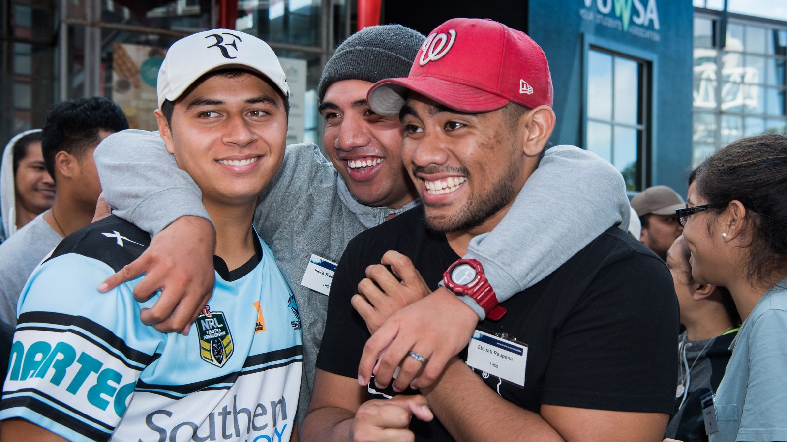 Pasifika camp – brotherhood three male students smile together for a photo.