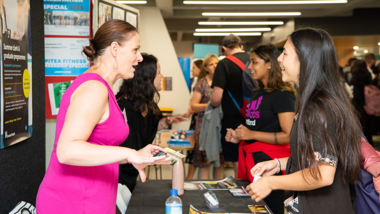 Employer interacting with a student at a careers expo.