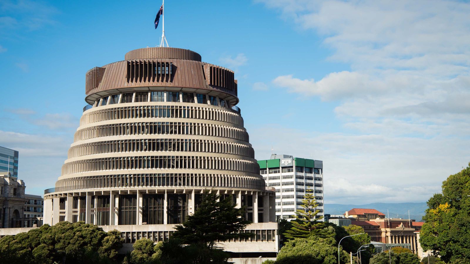 The Beehive, the Executive Wing of New Zealand Parliament Buildings, with Wellington School of Business and Government in the background.