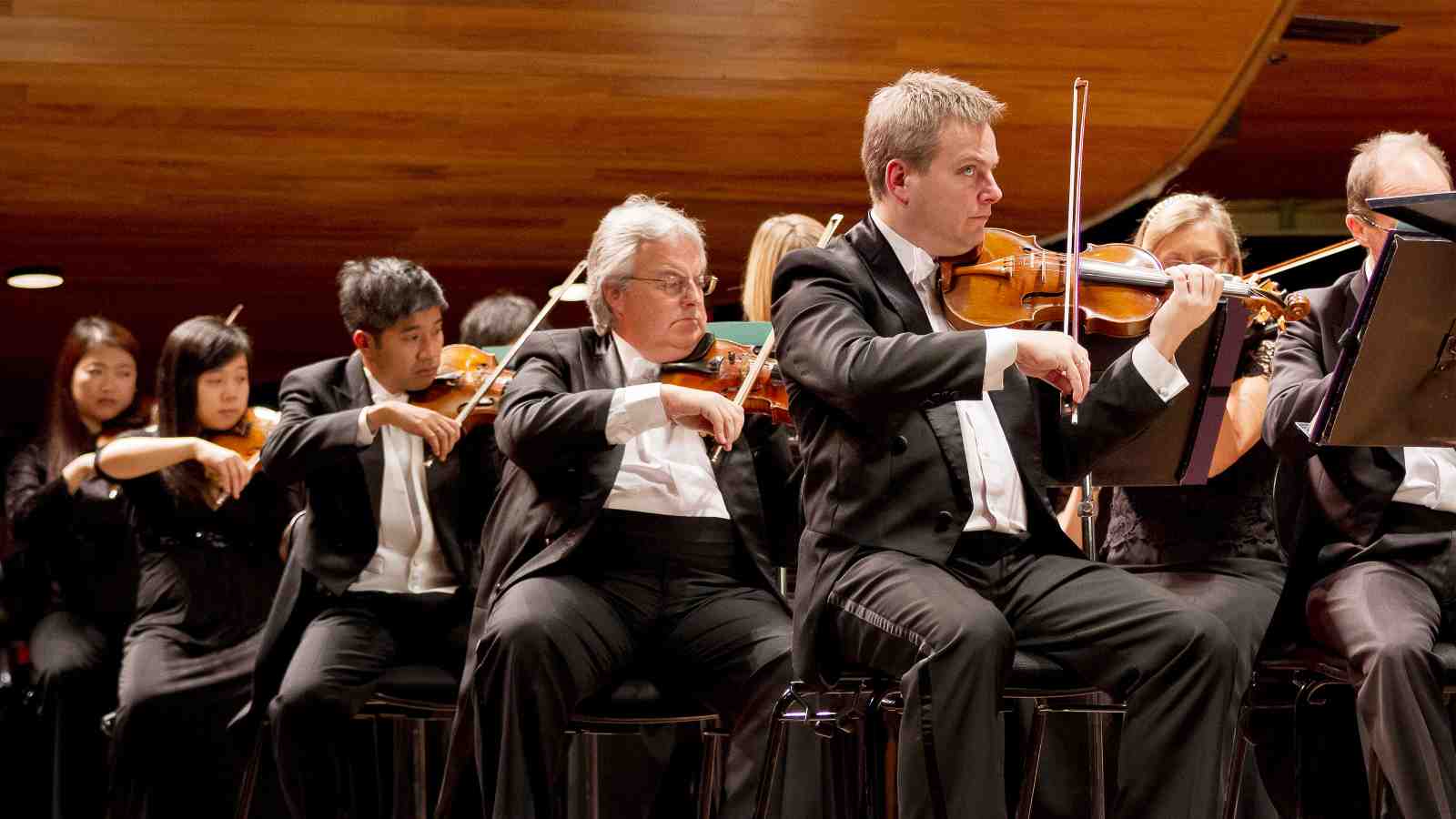 New Zealand Symphony Orchestra playing string instruments at a performance