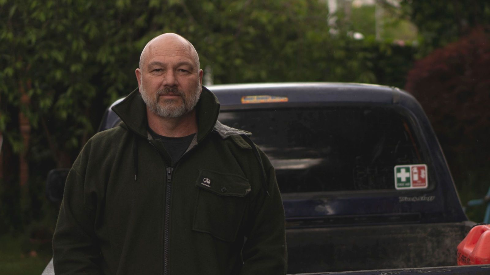 Man in front of black ute