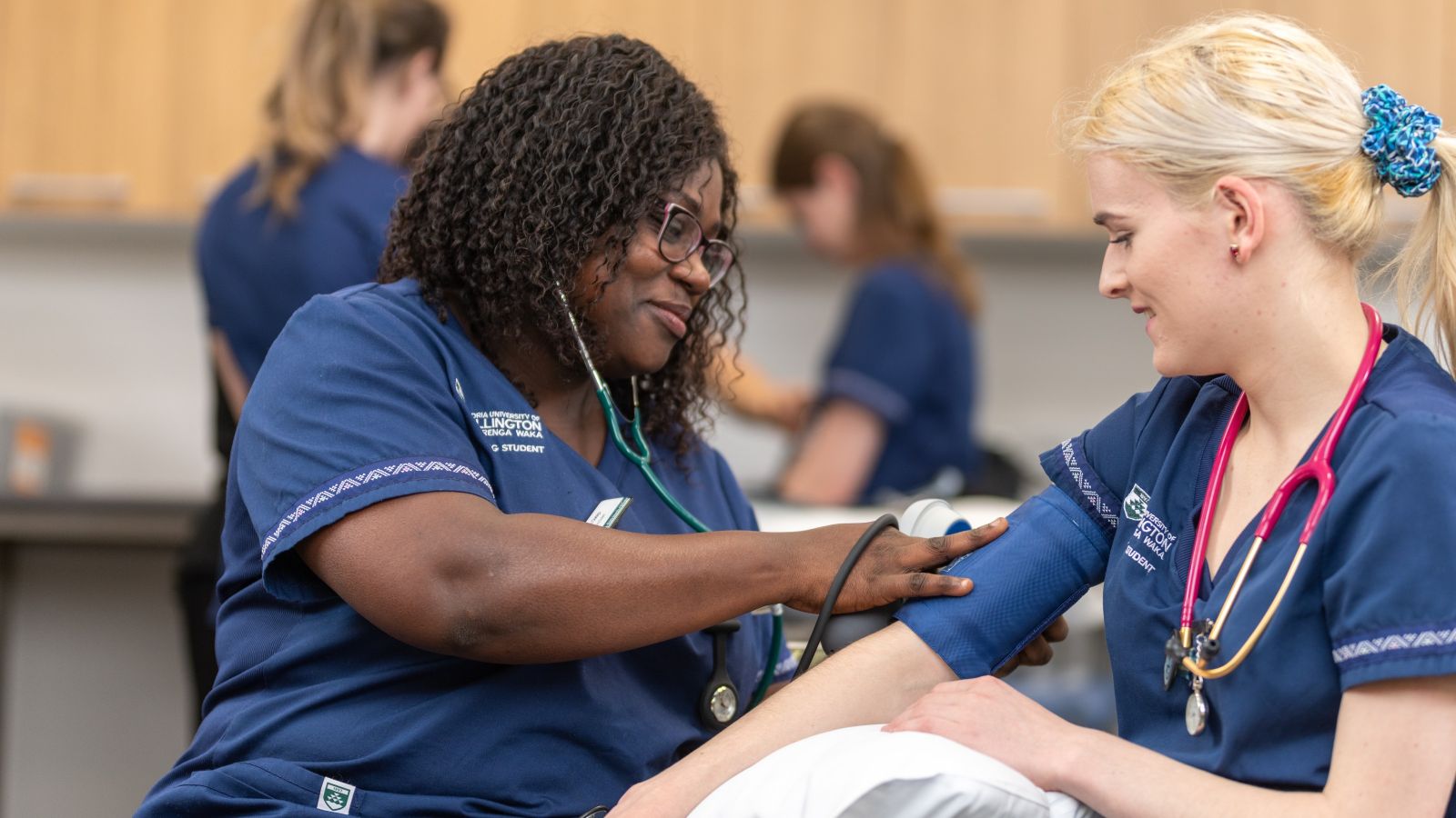 Student nurse takes blood pressure of another student nurse
