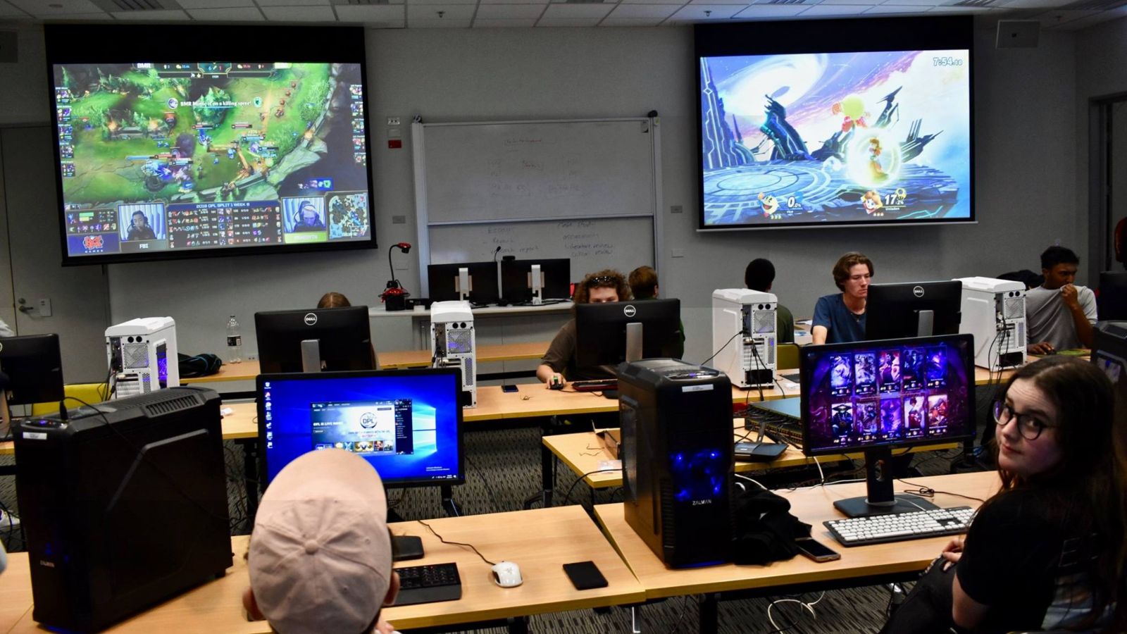 VESA event with students playing on computers, and Twitch streamers projected on large screens.