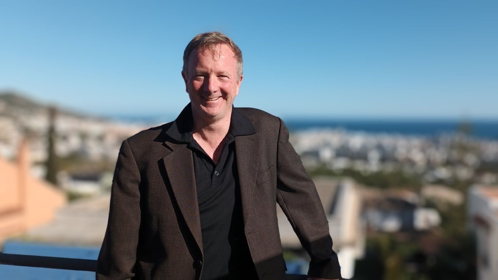 Man smiling in front of ocean view 