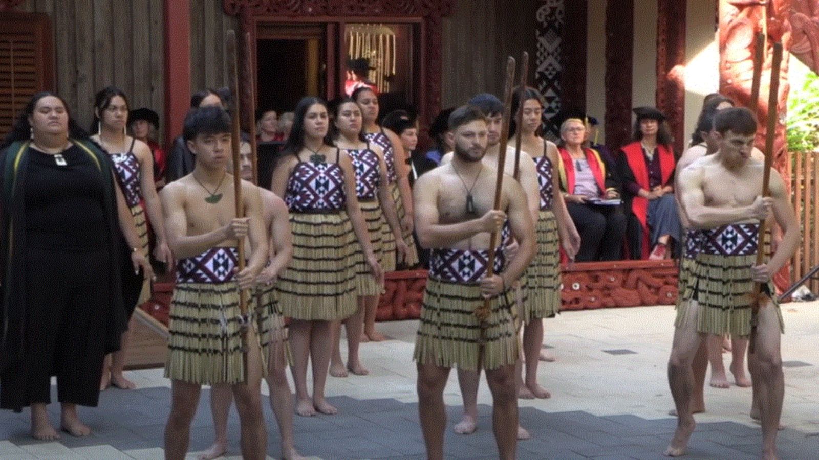 A welcoming dance outside a marae.