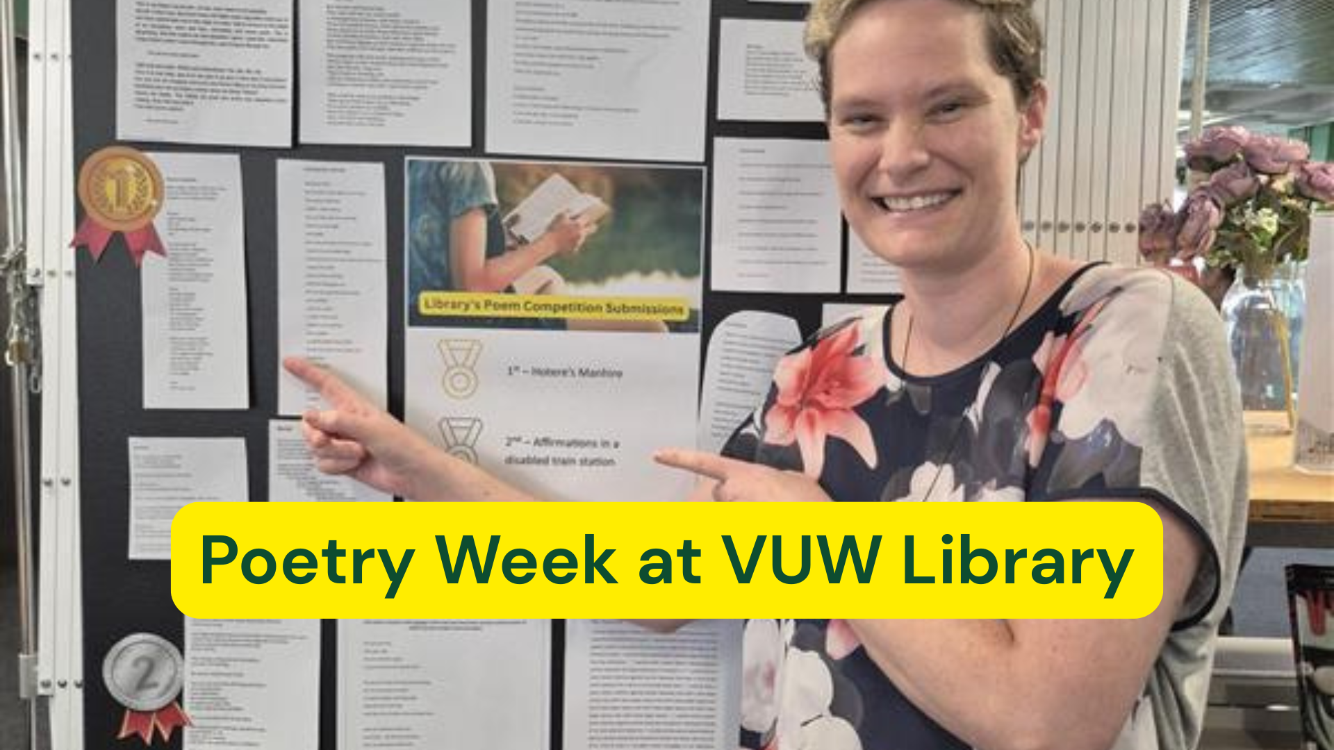 Our last year's winner, Anna Hoek-Sims, standing at our submissions wall from 2025. 