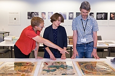 Ruth Lightbourne, Julie Sweetkind-Singer, and Mark Bagnall (left to right) discuss rare maps