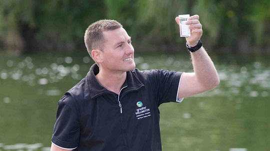 Mark Heath examines a water sample from the Hutt River