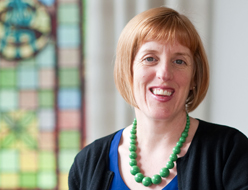 Profile photo of Therese Crocker, wearing a green bead necklace.