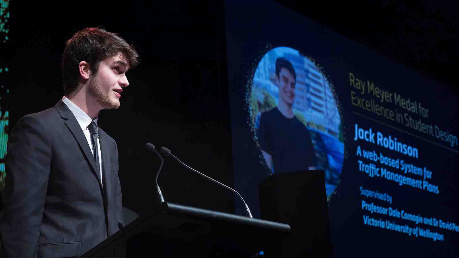 Jack Robinson speaking at a lectern.