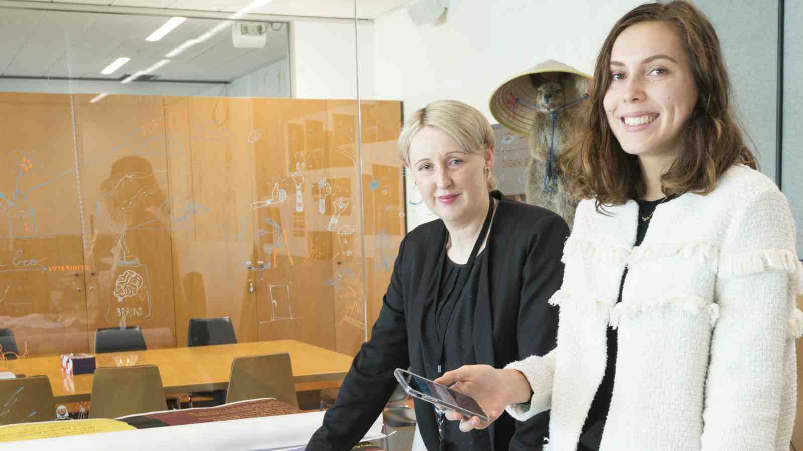 Kate Button from Te Papa and Jazz Klinkert standing at a table at Te Papa.