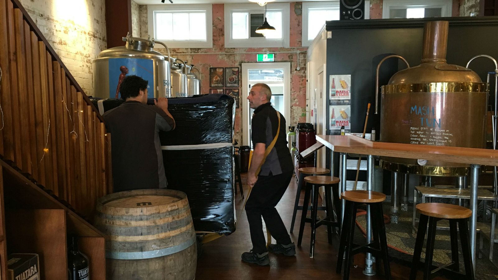Piano movers move the NZSM piano into the Tuatara Third Eye bar.