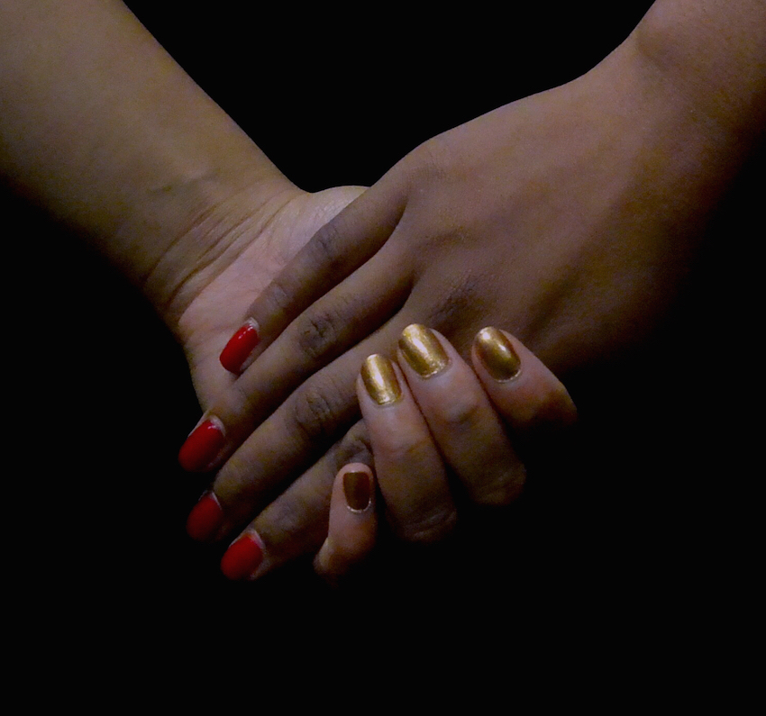 Image of two women's hands holding