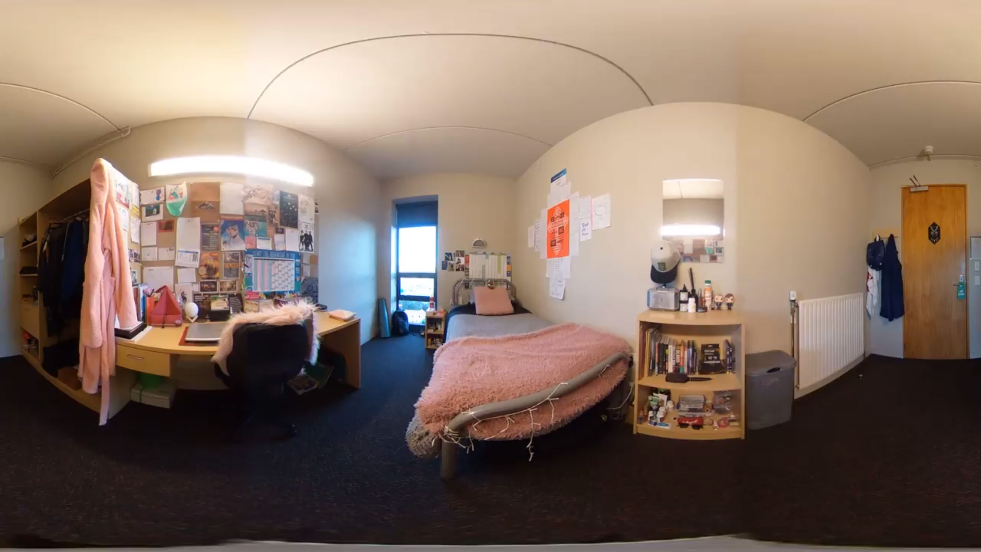 A panoramic view of an occupied bedroom with many pink accessories.