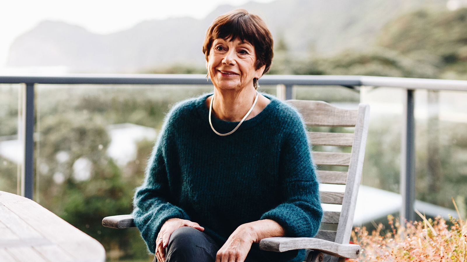 mary holm with silver necklace looking into distance, hills in background