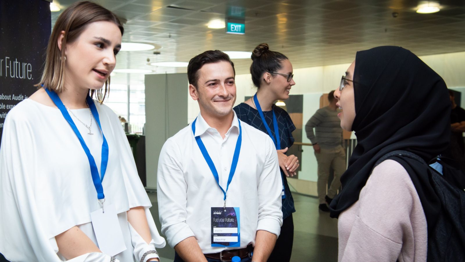 Two employers talking to a student.