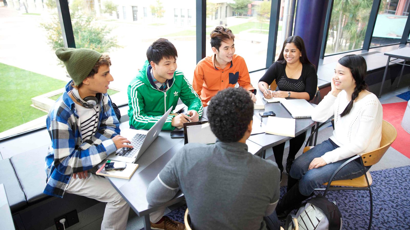 	A group of students sitting around a table discussing a project