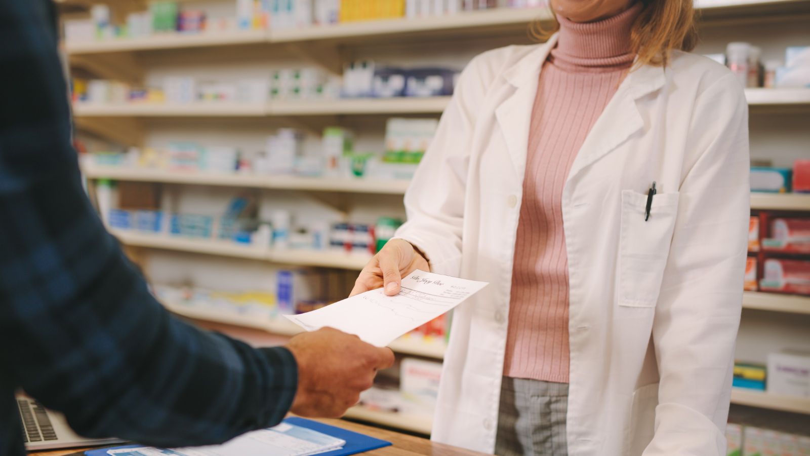 A pharmacist serving a customer