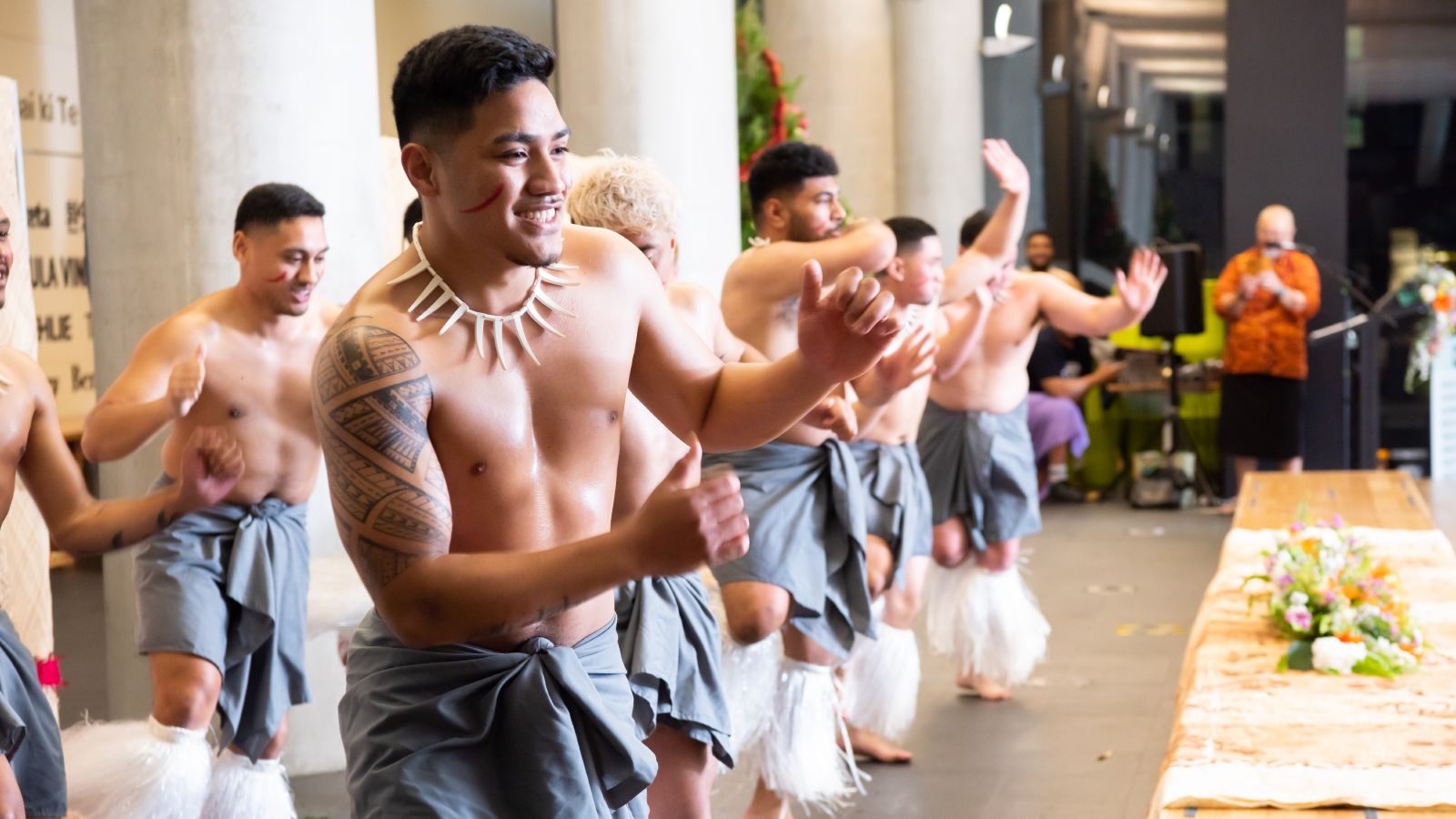 A group of male Pasifika students performing a traditional dance at a graduation celebration at Victoria University of Wellington