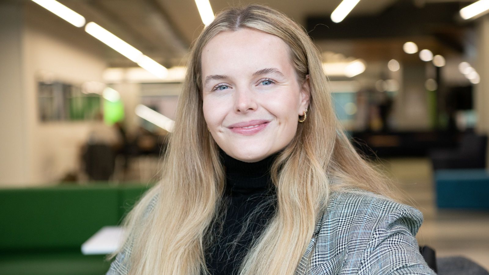 woman with long blond hair and blue eyes smiling