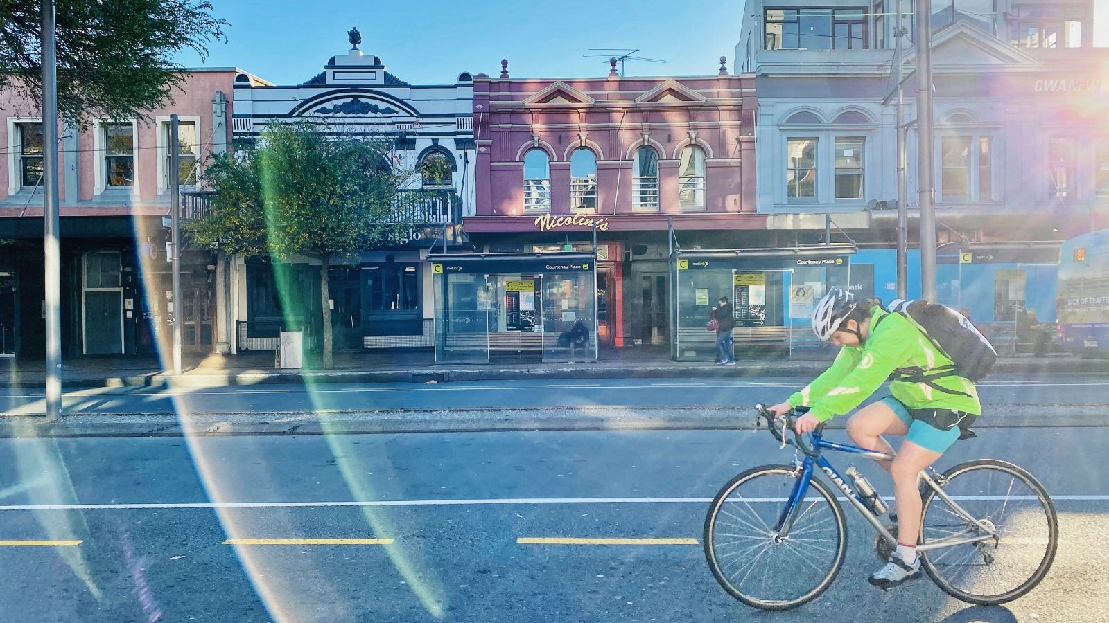 person on bike with newtown buildings in background